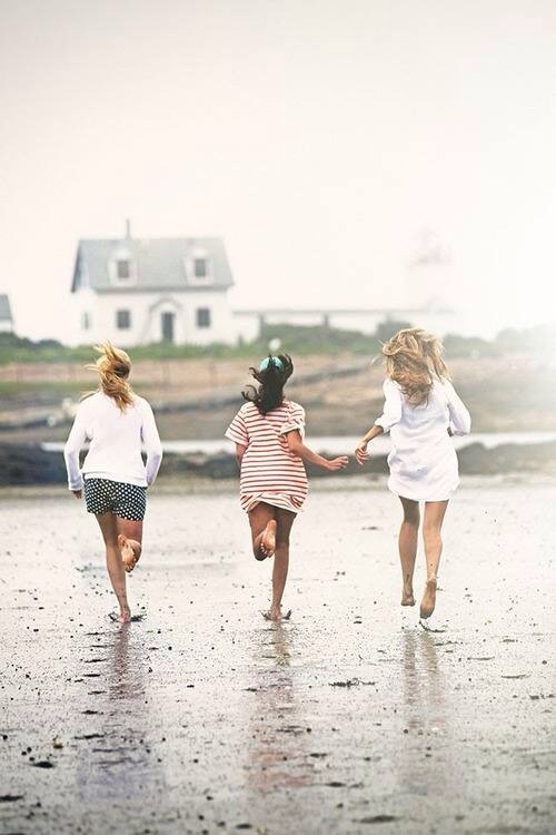 Friends running in sand