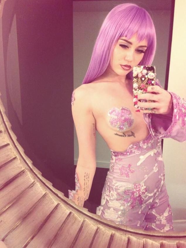 Miley Cyrus Decked Out in Pink Taking Selfie