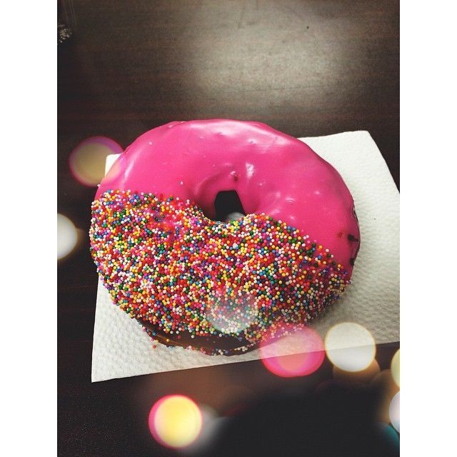 Half sprinkled pink donut