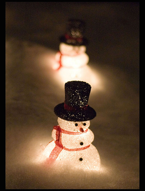Illuminated snowmen in the snow