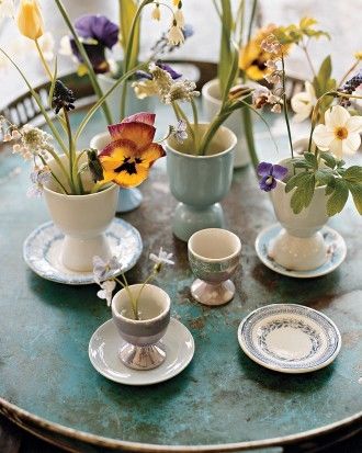 Spring flowers in egg cup vases