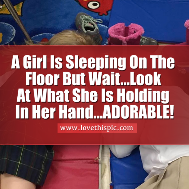 A Girl Is Sleeping On The Floor But Wait...Look At What She Is Holding In Her Hand...ADORABLE!