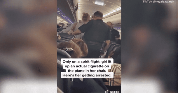 A Woman is kicked off of a flight after she lights a cigarette and blows smoke in another passenger's face - picture 2