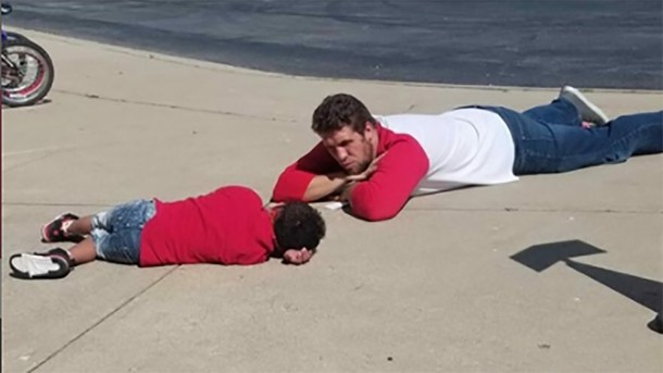 Assistant principal lays on the ground to help comfort kids with special needs having a hard day - picture 2