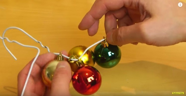He Slips Ornaments Onto A Simple Wire Hanger To Create An Easy Christmas Wreath In A Snap - picture 2