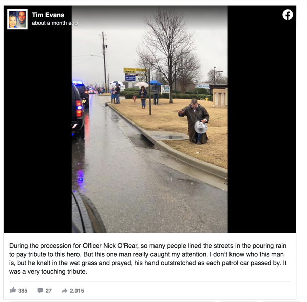 Picture displays man kneeling in the rain as procession for fallen cop drives by - picture 2