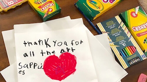 Teacher helps give away art supplies to all elementary school students in community - picture 3