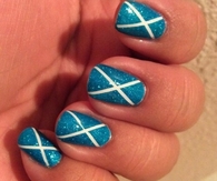 Sparkly cross blue nails