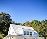 white house with a wrap around porch
