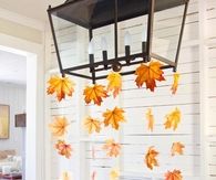Hang Leaf Streamers from Light Fixture over Thanksgiving Table