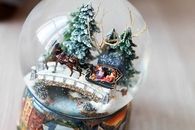 Santa and his reindeer snow globe