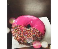 Half sprinkled pink donut