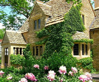 Charming Historical English Cottage with a Stone Exterior and Shingled Roof