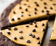CHOCOLATE COOKIE PIZZA WITH SALTED CARAMEL PEANUT BUTTER GREEK YOGURT FROSTING