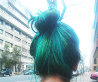Green dyed hair bun