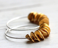 Small hoop earrings with a golden ruffle of petals