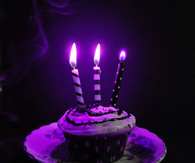 Neon purple candles and cupcake