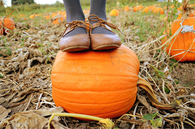 Girl standing on a pumpkin