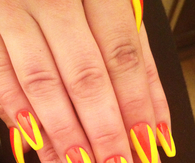 Squareletto nails with orange and yellow V shape