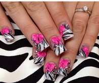 Zebra striped nails with pink bow design