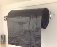 Paper towel holder for garbage bags