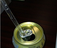 Put straw through the tab to keep it from rising