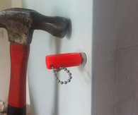 Use a magnet to find nails and studs in wall