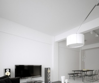 Black sofa in all white living room