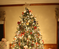 Lit christmas tree with gifts