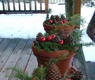 Pot holder full of ornaments and pinecones