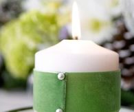 Green ribbon wrapped candle
