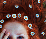 Freckled model with brunette floral hair