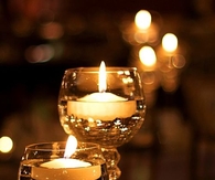 Floating candles in wine glasses